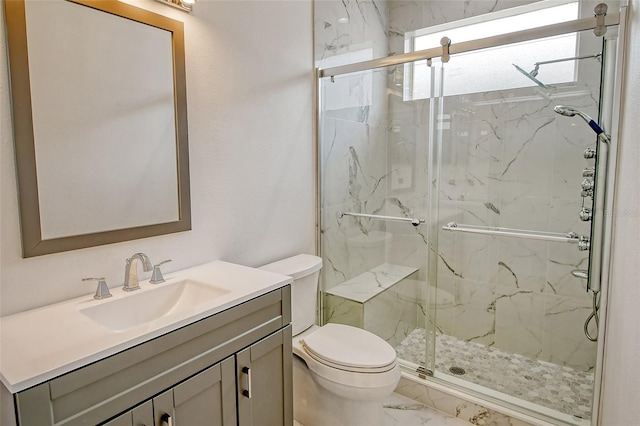 bathroom with vanity, toilet, and walk in shower