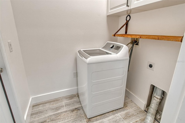 laundry room featuring cabinets and washer / clothes dryer