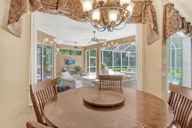 dining room featuring ceiling fan with notable chandelier and a wealth of natural light