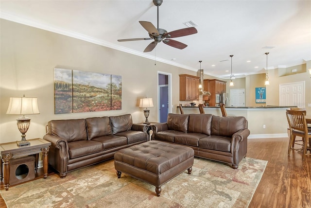 living room featuring crown molding, ceiling fan, and light wood-type flooring