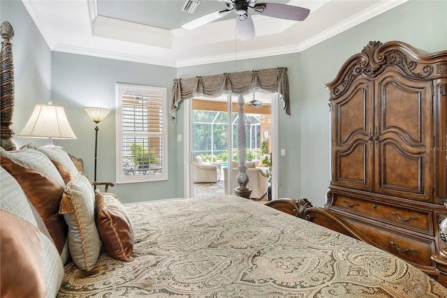 bedroom featuring ceiling fan, ornamental molding, access to exterior, and a raised ceiling