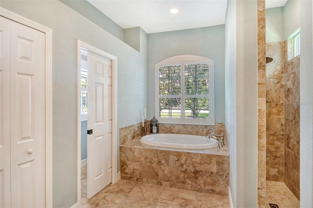 bathroom featuring separate shower and tub