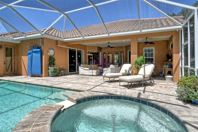 view of pool featuring an in ground hot tub, a patio area, ceiling fan, and glass enclosure