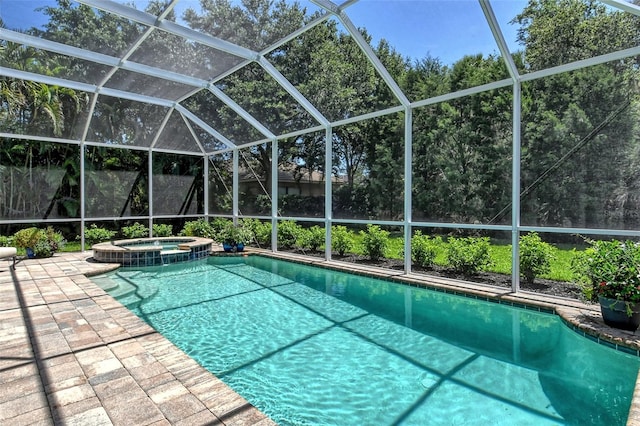 view of swimming pool with an in ground hot tub, a lanai, and a patio area