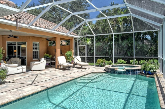 view of swimming pool with an in ground hot tub, a patio, ceiling fan, and glass enclosure