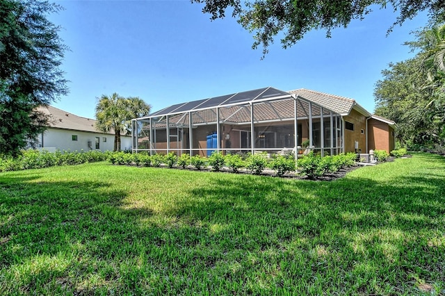 back of house featuring a yard and a lanai