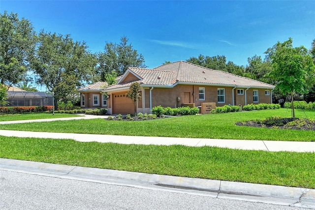 view of front of house featuring a garage and a front lawn