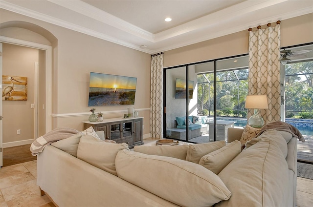 living room featuring crown molding and a raised ceiling