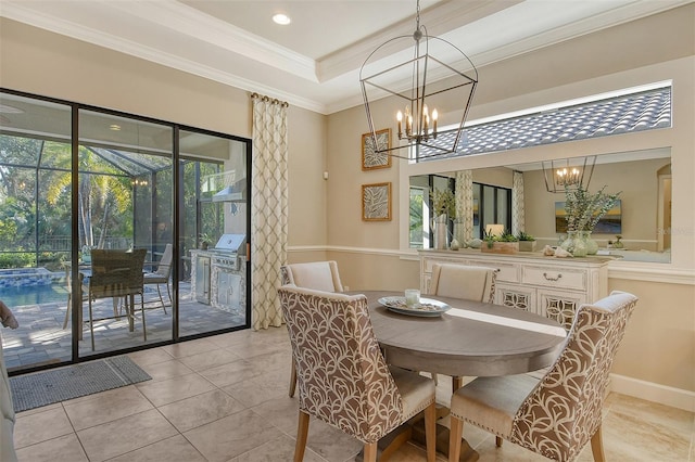 tiled dining area featuring ornamental molding, a tray ceiling, and a notable chandelier