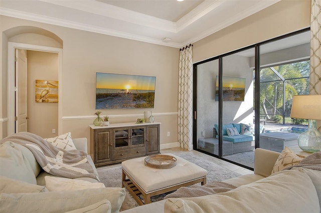 living room with ornamental molding and a raised ceiling