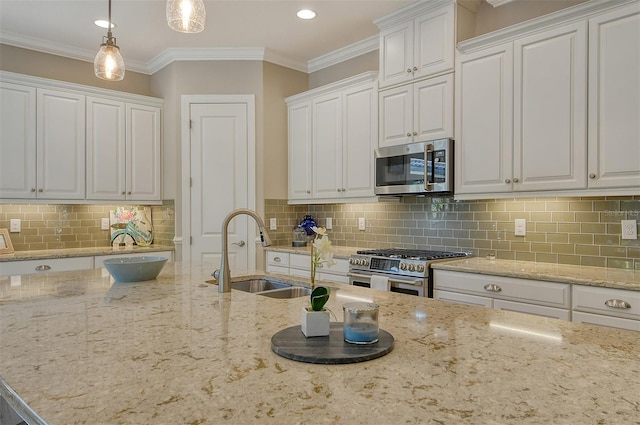 kitchen with sink, crown molding, white cabinetry, hanging light fixtures, and stainless steel appliances