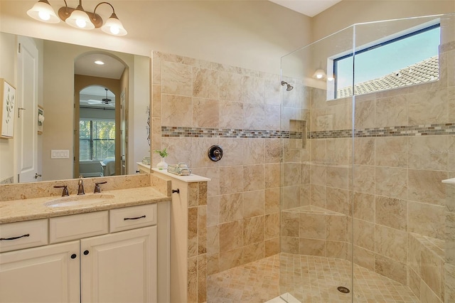 bathroom featuring vanity and tiled shower