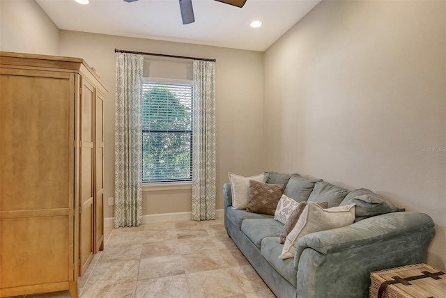 living room featuring ceiling fan and a wealth of natural light