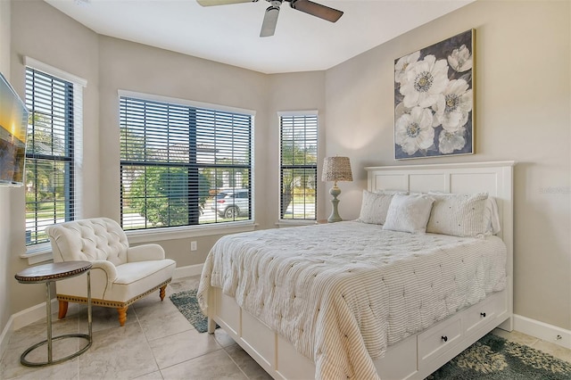 tiled bedroom featuring ceiling fan