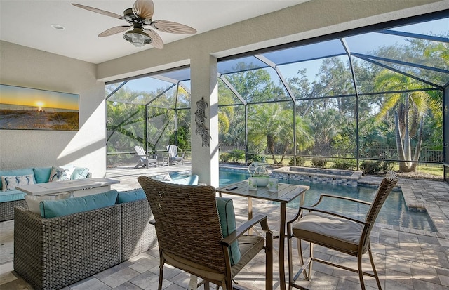 view of patio / terrace with a lanai, outdoor lounge area, and ceiling fan