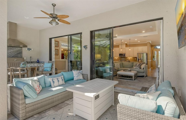 interior space featuring ceiling fan and an outdoor hangout area