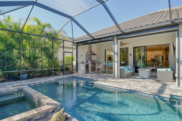 view of swimming pool featuring a patio, outdoor lounge area, exterior kitchen, an in ground hot tub, and ceiling fan