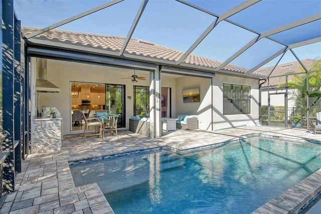 back of house featuring an outdoor living space, a lanai, ceiling fan, and a patio area