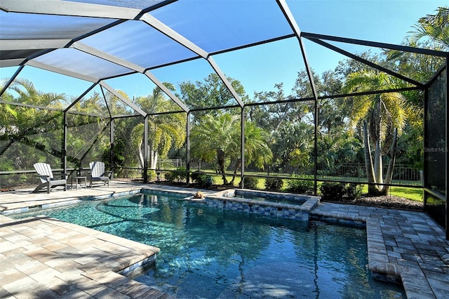 view of pool with a patio and glass enclosure