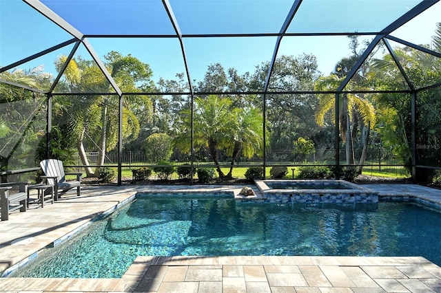 view of swimming pool with a patio area and glass enclosure