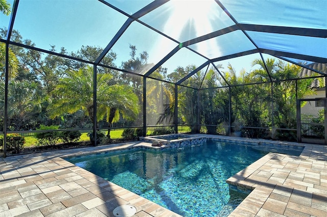 view of swimming pool with a patio and glass enclosure