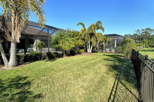 view of yard with glass enclosure