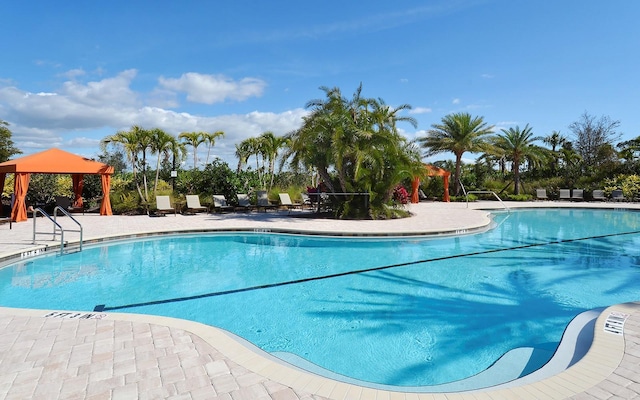 view of swimming pool with a gazebo and a patio area