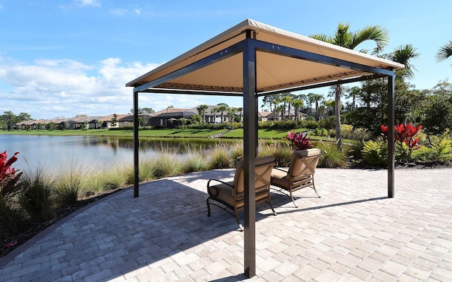 view of patio / terrace with a gazebo and a water view