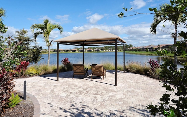 view of patio / terrace with a gazebo and a water view