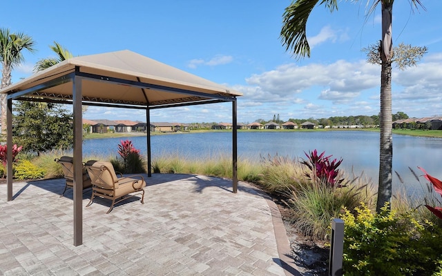 view of patio / terrace featuring a gazebo and a water view