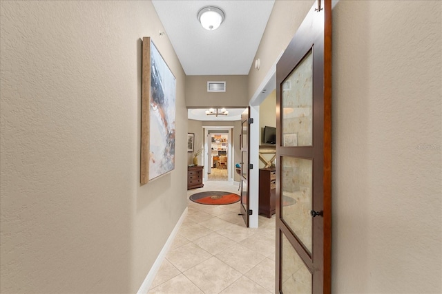 hallway featuring light tile patterned floors