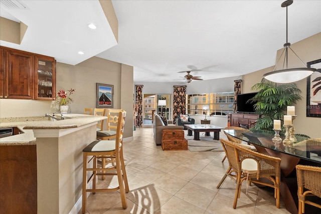 tiled dining area featuring ceiling fan