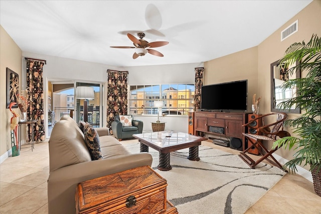 tiled living room with ceiling fan