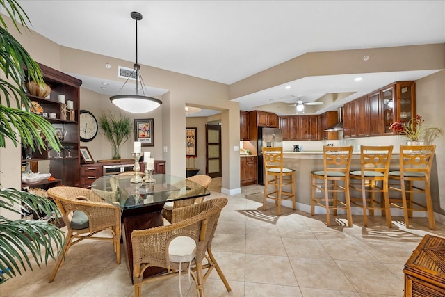 dining space with ceiling fan and light tile patterned floors