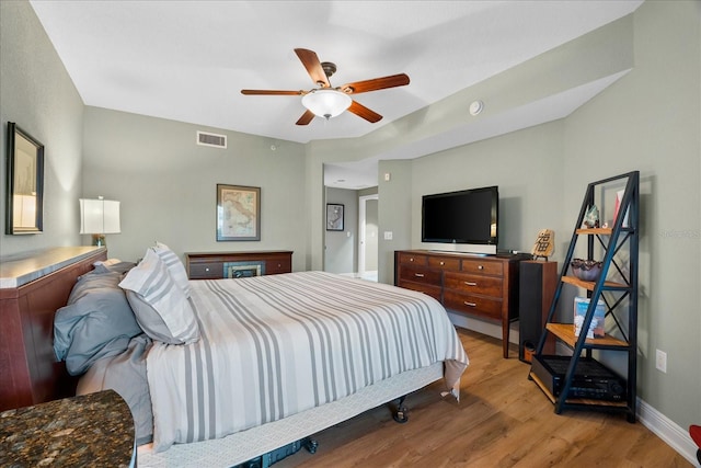 bedroom with ceiling fan and wood-type flooring