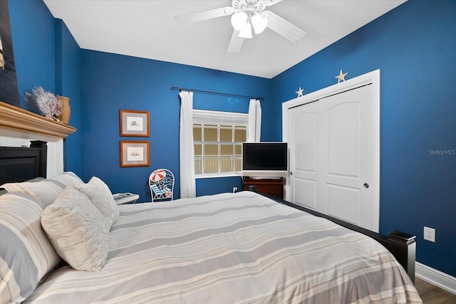 bedroom with hardwood / wood-style floors, ceiling fan, and a closet