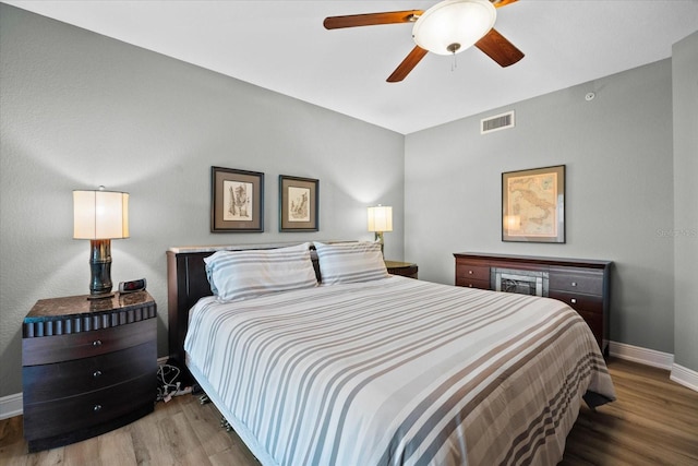 bedroom with hardwood / wood-style flooring and ceiling fan