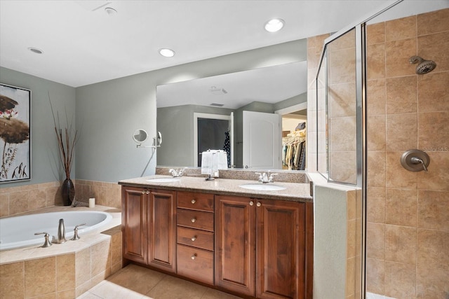 bathroom featuring tile patterned floors, separate shower and tub, and vanity