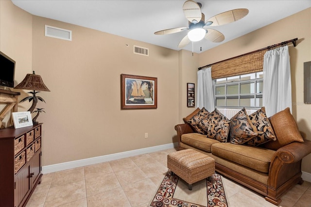 tiled living room with ceiling fan