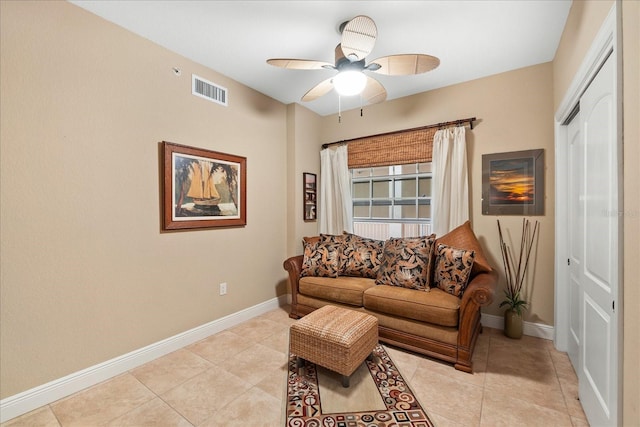 tiled living room featuring ceiling fan