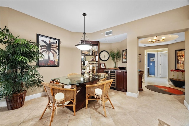 dining area featuring light tile patterned flooring and a notable chandelier