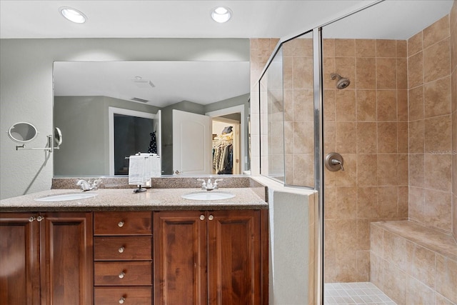 bathroom featuring vanity and a shower with door