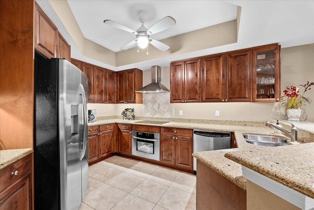 kitchen featuring sink, stainless steel appliances, light stone countertops, light tile patterned flooring, and wall chimney exhaust hood