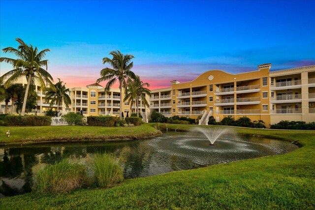 outdoor building at dusk featuring a water view