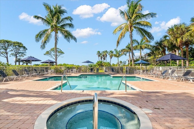 view of pool featuring a hot tub and a patio