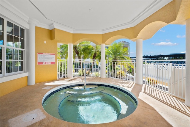 view of swimming pool featuring a hot tub