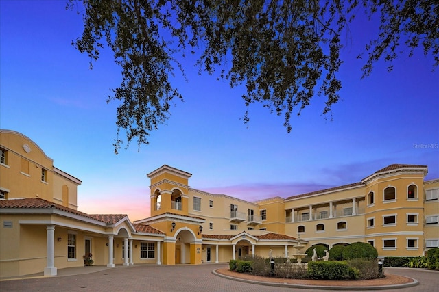 view of outdoor building at dusk