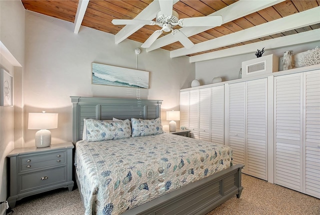 bedroom featuring ceiling fan, beam ceiling, light carpet, and wooden ceiling