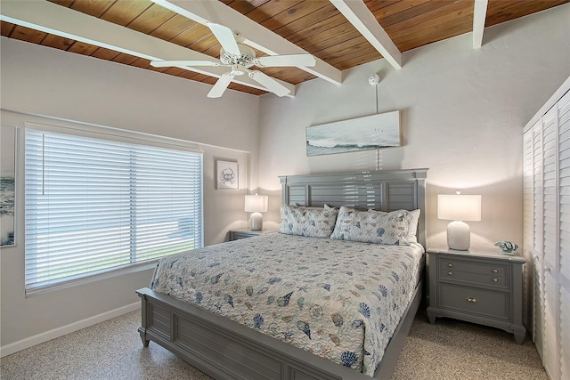 bedroom featuring beamed ceiling, ceiling fan, light carpet, and wooden ceiling