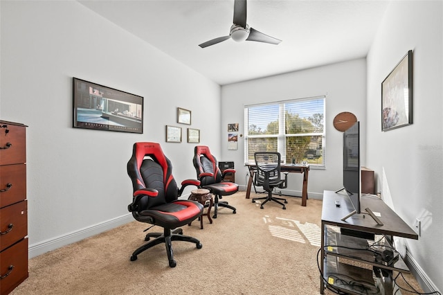 carpeted home office featuring ceiling fan